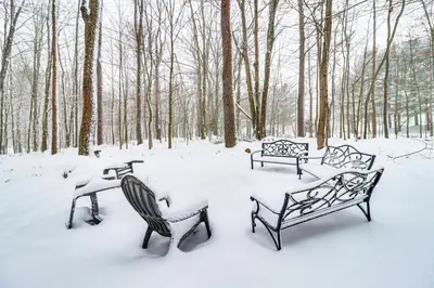 three benches covered in snow in a park at Scenic Views! Clifton Twp Chalet with Fire Pit, Deck in Gouldsboro