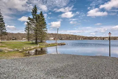 a small island in the middle of a lake at Pool, Beach and Lake Access Poconos Cabin Escape! in Tobyhanna