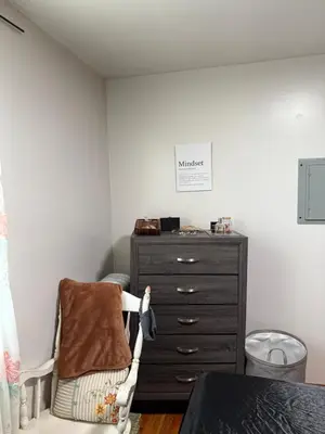a bedroom with a dresser and a chair next to a dresser at Private Room 15 Mins to Times Square NYC in West New York