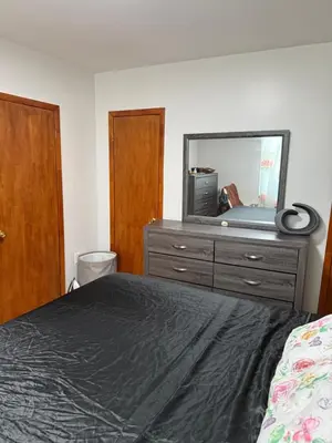 a bedroom with a bed and a dresser with a mirror at Private Room 15 Mins to Times Square NYC in West New York