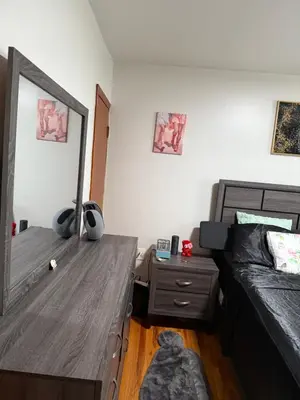 a bedroom with a bed and a mirror and a table at Private Room 15 Mins to Times Square NYC in West New York