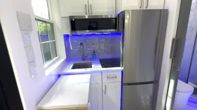 a kitchen with a sink and a refrigerator at Modern Tiny Home Fast NYC Access Private in Jersey City