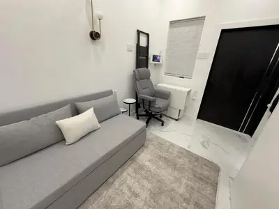 a living room with a couch and a chair at Modern Tiny Home Fast NYC Access Private in Jersey City
