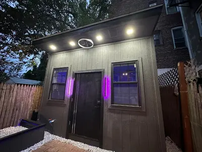 a small house with a door and lights on it at Modern Tiny Home Fast NYC Access Private in Jersey City