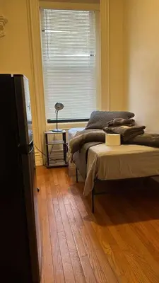 a bedroom with two beds and a window at New York City Guesthouse 3 in New York