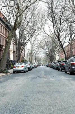 a street with cars parked on the side of the road at New York City Guesthouse 3 in New York