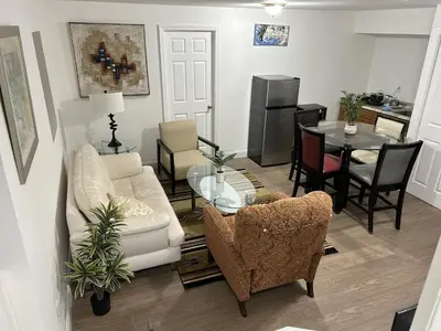 a living room with a couch and a table at 1BR Apartment - Unit A - With Parking and 10min Walk to NYC Train Station in Mount Vernon