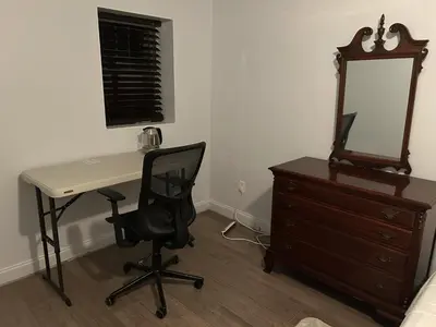 a desk with a chair and a mirror and a dresser at 1BR Apartment - Unit A - With Parking and 10min Walk to NYC Train Station in Mount Vernon