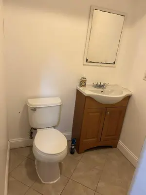a bathroom with a toilet and a sink at 1BR Apartment - Unit A - With Parking and 10min Walk to NYC Train Station in Mount Vernon