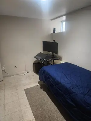 a bedroom with a bed and a desk with a computer at Bridgeport East Main in Bridgeport