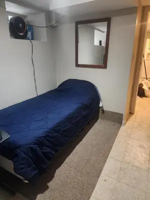 a bedroom with a blue bed and a mirror at Bridgeport East Main in Bridgeport