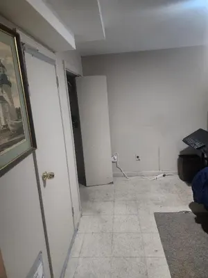 an empty room with a white wall and a door at Bridgeport East Main in Bridgeport
