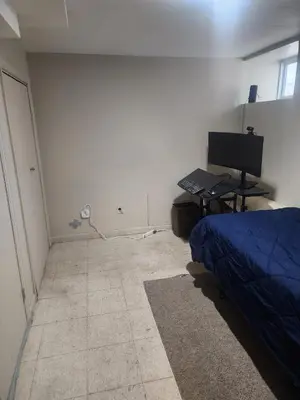 a bedroom with a bed and a desk and a computer at Bridgeport East Main in Bridgeport