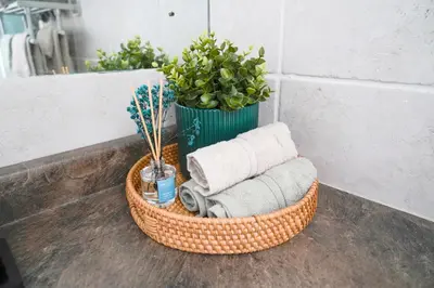 a basket with towels and a plant in a bathroom at Family River Valley Retreat with Fireplace in Sparrow Bush