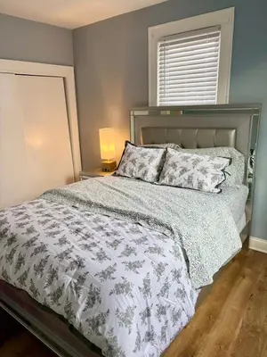a bedroom with a bed with a white comforter and a window at Heavenly Retreat Luxury 3 Bedrooms 1 Bathroom in East Orange