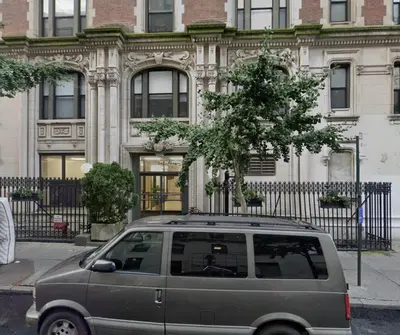 a van parked in front of a building with a tree at Elegant NYC Apartment with Designer Touches in New York