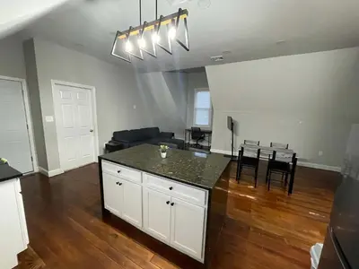 a kitchen and living room with a table and a couch at Apartment in Middletown-Wesleyan 301 in Middletown