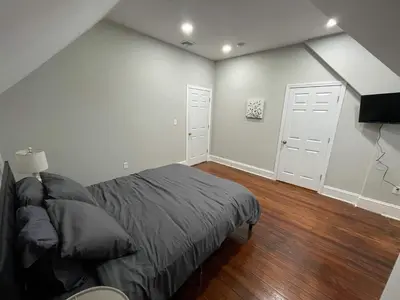 a bedroom with a bed and two white doors at Apartment in Middletown-Wesleyan 301 in Middletown