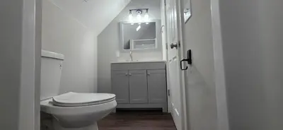 a white bathroom with a toilet and a sink at Apartment in Middletown-Wesleyan 301 in Middletown