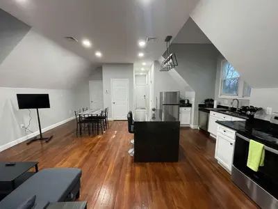 a kitchen and living room with a table and chairs at Apartment in Middletown-Wesleyan 301 in Middletown