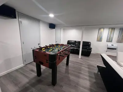 a room with a foosball table in a living room at Entire house for big group-minutes from Hartford in East Hartford