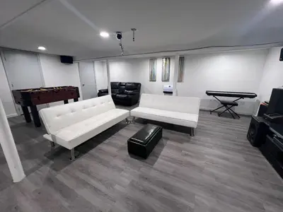 a living room with white couches and a pool table at Entire house for big group-minutes from Hartford in East Hartford