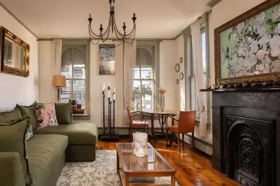a living room with a couch and a fireplace at The Mulford Alden House in Hudson