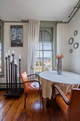 a dining room with a white table and chairs at The Mulford Alden House in Hudson