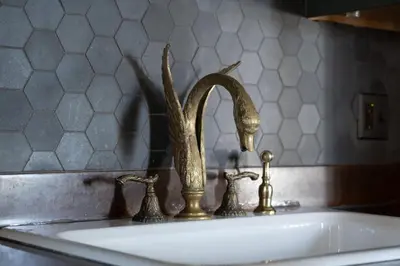 a bathroom sink with a bronze faucet on it at The Mulford Alden House in Hudson