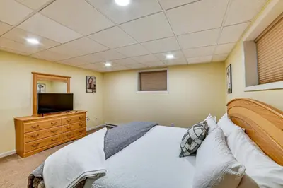 a bedroom with a bed and a flat screen tv at Catskills Group Getaway on 50 Scenic Acres! in South Kortright