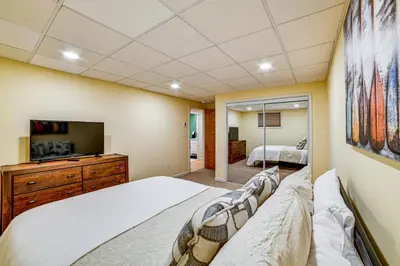 a bedroom with a large bed and a tv at Catskills Group Getaway on 50 Scenic Acres! in South Kortright