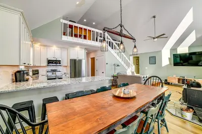 a kitchen and dining room with a wooden table and chairs at Catskills Group Getaway on 50 Scenic Acres! in South Kortright