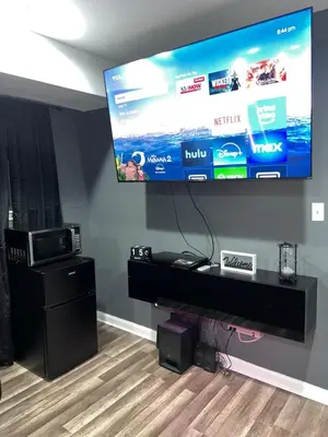 a large flat screen tv hanging on a wall at Comfortstayrus in Orange
