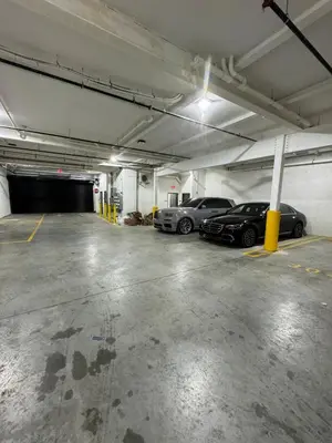 a parking garage with two cars parked in it at Luxurious and Spacious Apt with Parking 20 min to NYC in West New York