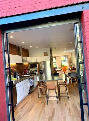 a kitchen and dining room with a table and chairs at Elegant Historic Harlem Townhouse Apartments for Summer in New York