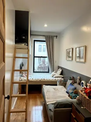 a bedroom with two bunk beds and a window at Elegant Historic Harlem Townhouse Apartments for Summer in New York