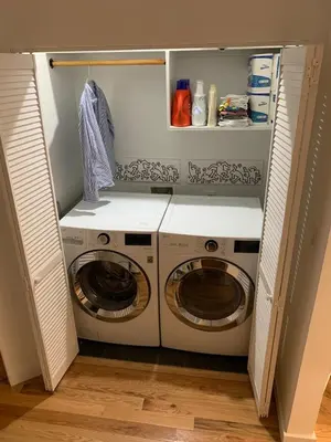a laundry room with a washer and dryer at Elegant Historic Harlem Townhouse Apartments for Summer in New York