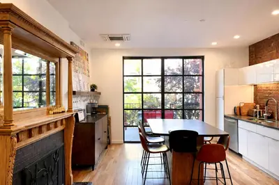 a kitchen with a table and chairs in a kitchen at Elegant Historic Harlem Townhouse Apartments for Summer in New York