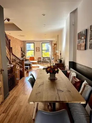 a living room with a wooden table and chairs at Elegant Historic Harlem Townhouse Apartments for Summer in New York