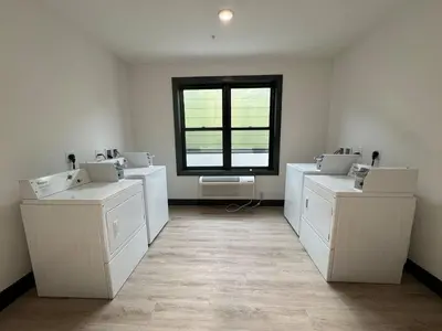 a bathroom with three sinks and a window at Spacious Apt 15 mins to NYC with Free Indoor Parking in West New York