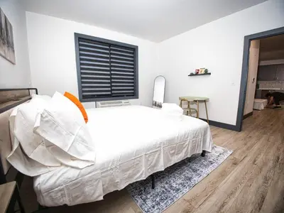 a bedroom with a large white bed and a window at Excellent Location-20 Minutes to NYC-Free Parking in West New York