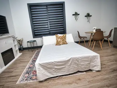 a bedroom with a bed and a table with chairs at Excellent Location-20 Minutes to NYC-Free Parking in West New York