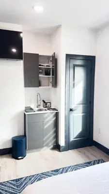 a kitchen with a sink and a door in a room at City excitement -Studio 20 Minutes to (42st) NYC in West New York