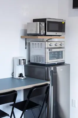 a kitchen with a counter with a microwave and a stove at City excitement -Studio 20 Minutes to (42st) NYC in West New York