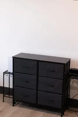 a black dresser with a black top at City excitement -Studio 20 Minutes to (42st) NYC in West New York