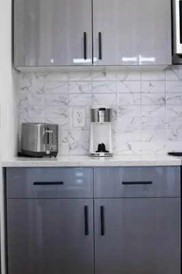 a kitchen counter with a toaster and a coffee maker at Stylish Studio Apt-Outside NYC in West New York