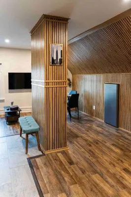 a room with a wooden wall with a bench and a table at Bright, Cozy, and Peaceful Two Bedroom Apt Near NYC in North Bergen
