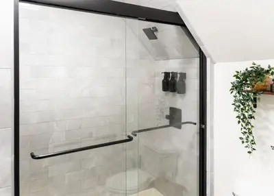 a shower with a glass door in a bathroom at Bright, Cozy, and Peaceful Two Bedroom Apt Near NYC in North Bergen
