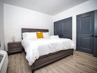 a bedroom with a bed and two blue doors at Prime Location with Free Parking Near NYC in West New York