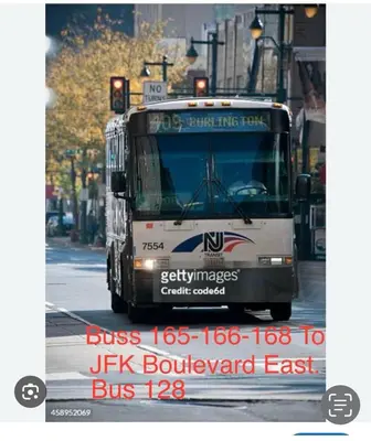 a bus is driving down a city street at Private room B in West NYNJ 12mints from NYCity Times Square in West New York